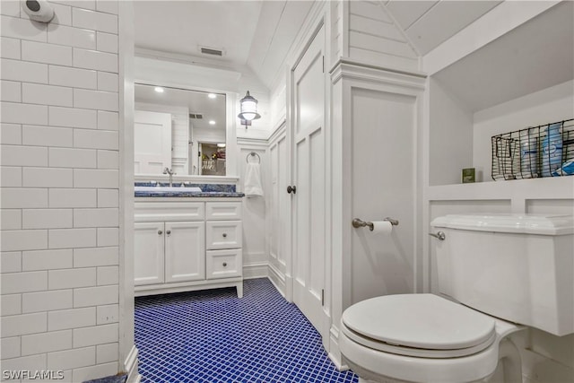 bathroom featuring toilet and vanity