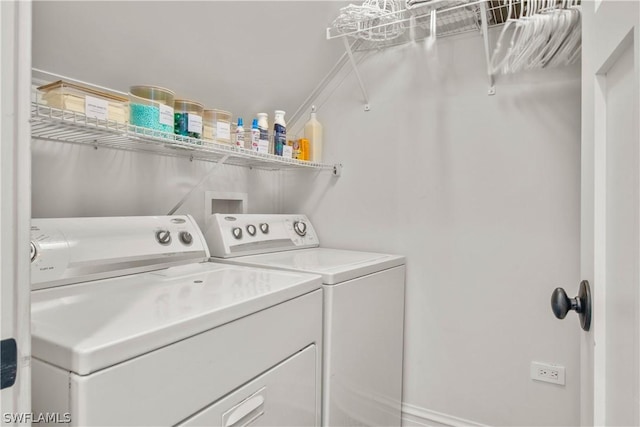 clothes washing area with washer and clothes dryer