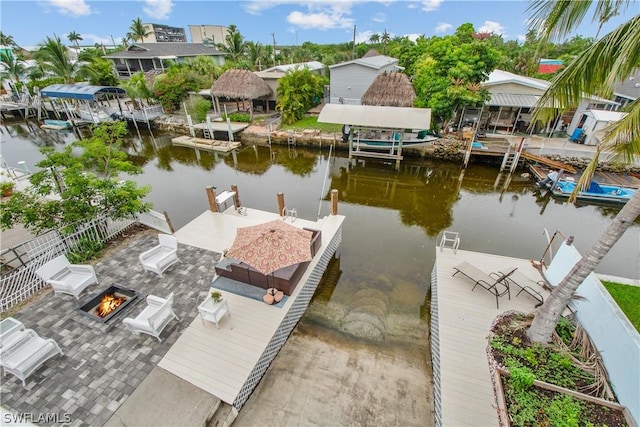 dock area featuring an outdoor fire pit and a water view