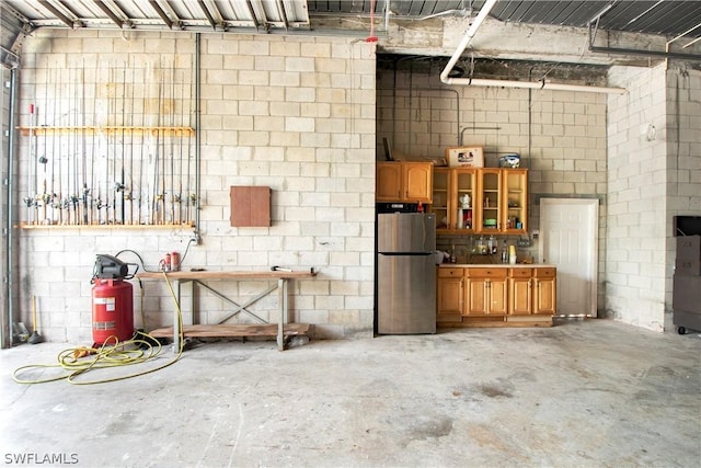 garage with stainless steel refrigerator