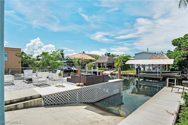 exterior space with an outdoor living space, a water view, and a gazebo
