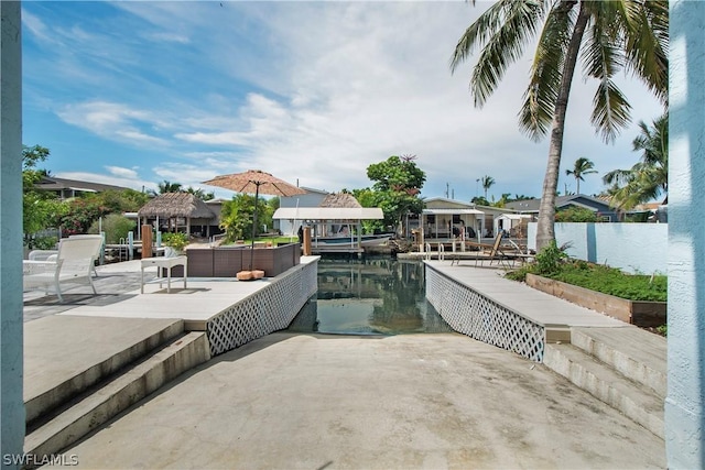 view of swimming pool featuring a patio, a water view, and a gazebo