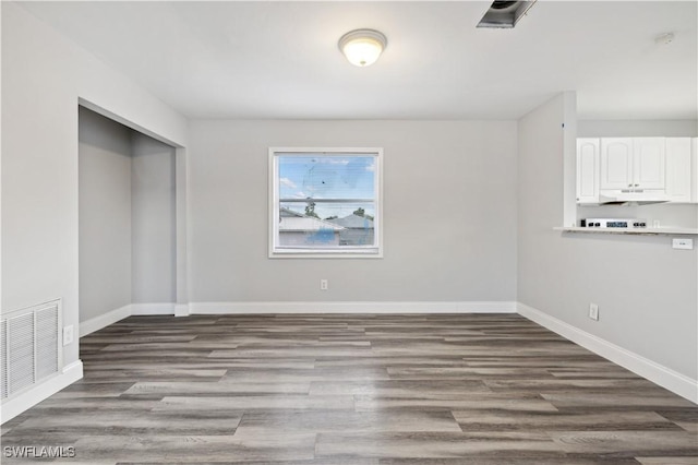 unfurnished dining area featuring wood-type flooring