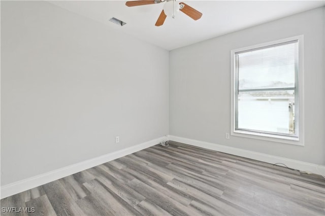 spare room with light hardwood / wood-style floors and ceiling fan