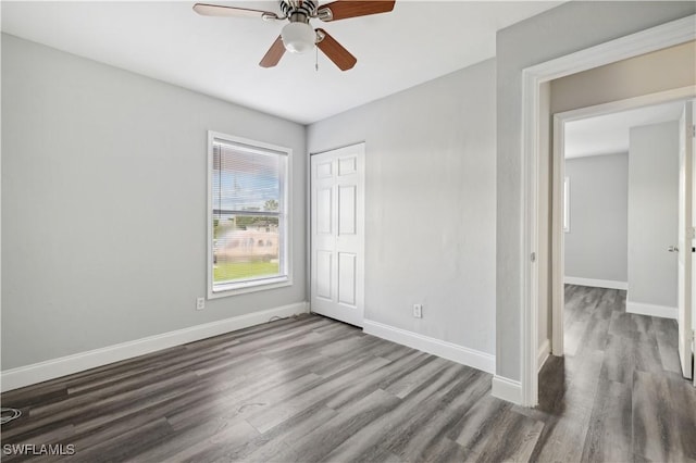 unfurnished bedroom with dark hardwood / wood-style flooring and ceiling fan