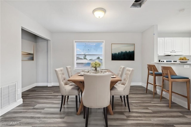 dining area featuring dark hardwood / wood-style flooring