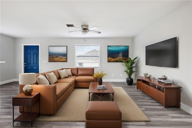 living room featuring hardwood / wood-style flooring and ceiling fan