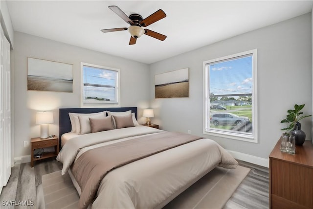 bedroom with hardwood / wood-style flooring and ceiling fan