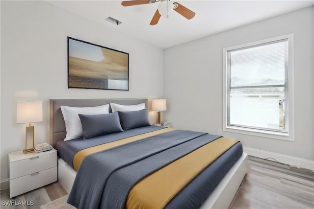 bedroom featuring light hardwood / wood-style floors and ceiling fan