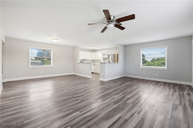 unfurnished living room featuring ceiling fan, plenty of natural light, and hardwood / wood-style floors