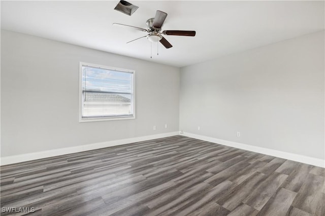 empty room featuring ceiling fan and dark wood-type flooring