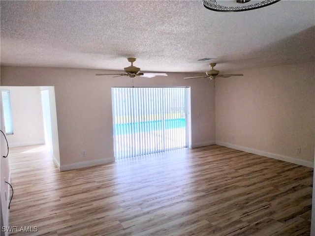 spare room with hardwood / wood-style flooring, ceiling fan, and a textured ceiling