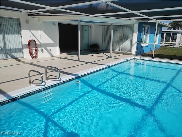 view of pool with a lanai and a patio area