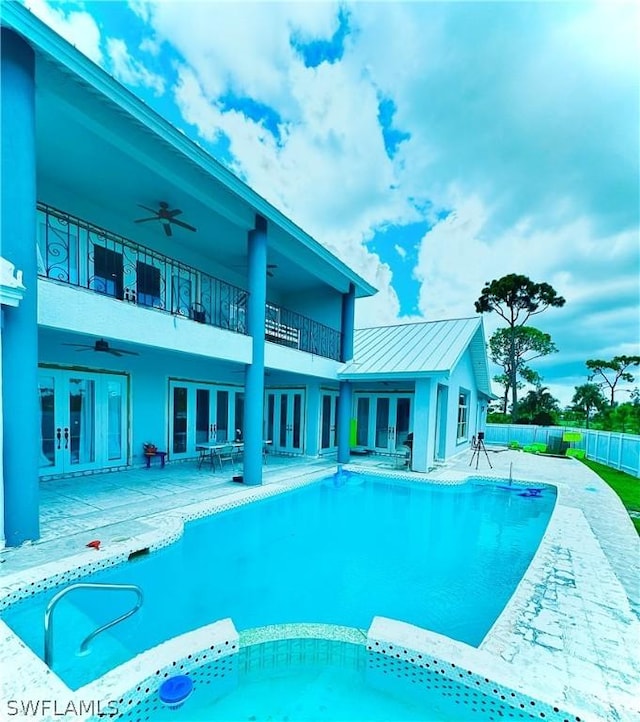 view of pool with ceiling fan, french doors, and a patio