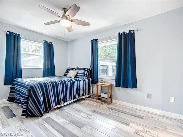 bedroom with ceiling fan and hardwood / wood-style flooring