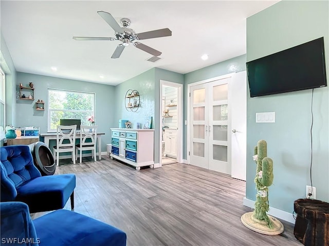 living room with ceiling fan and wood-type flooring