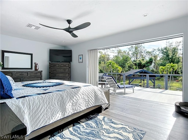 bedroom featuring ceiling fan, hardwood / wood-style flooring, and access to outside