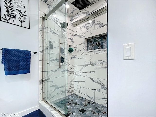 bathroom featuring a shower with shower door