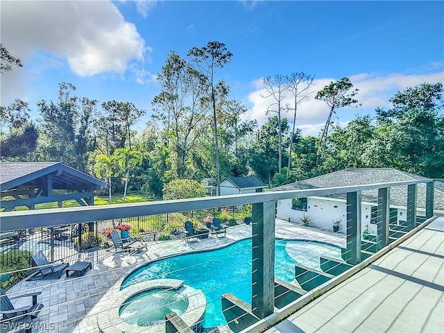 view of pool with a patio area, a community hot tub, a gazebo, and an outbuilding