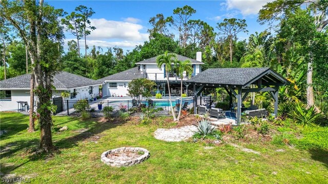15711 Anderson Ln, Fort Myers, FL 33912 - view of yard with an outdoor living space with a fire pit, a gazebo, a patio area, and a balcony
