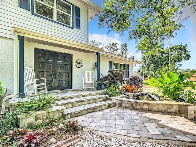 property entrance with covered porch