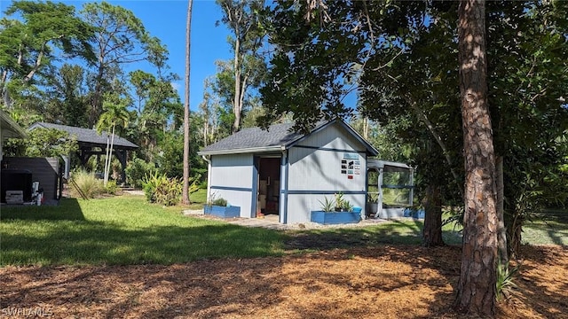 view of outbuilding featuring a yard