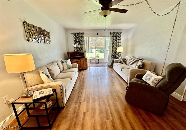 living room with ceiling fan and wood-type flooring