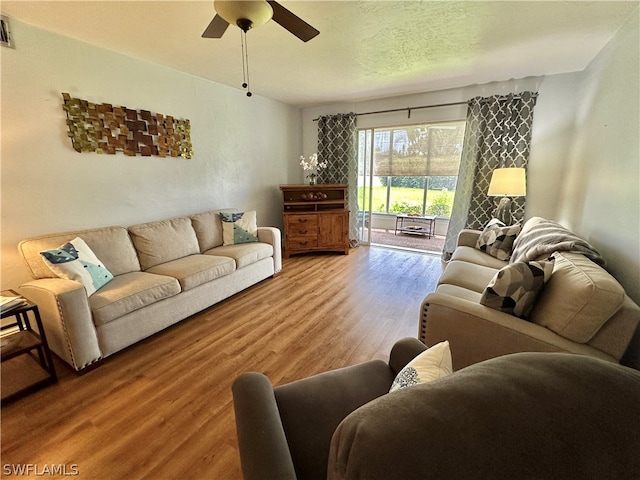 living room with ceiling fan and wood-type flooring