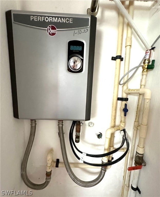 utility room with tankless water heater