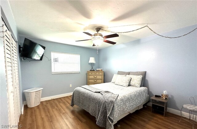 bedroom with ceiling fan and wood-type flooring