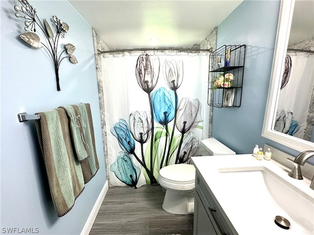 bathroom with vanity, wood-type flooring, and toilet