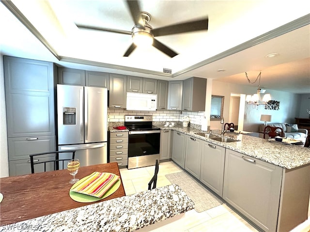 kitchen featuring tasteful backsplash, sink, stainless steel appliances, and light tile patterned floors