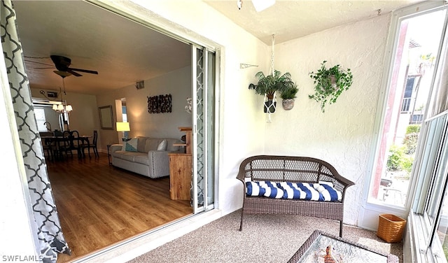 exterior space with ceiling fan with notable chandelier