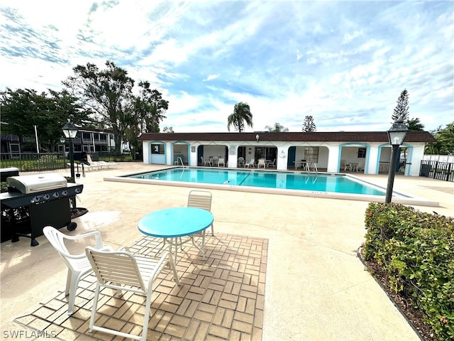 view of pool featuring area for grilling and a patio area