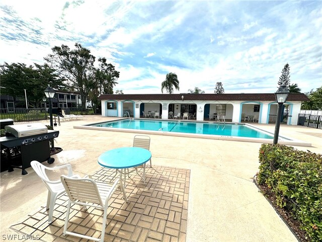 2828 Jackson St Unit I-1, Fort Myers, FL 33901 - community pool featuring a patio area, grilling area, and fence