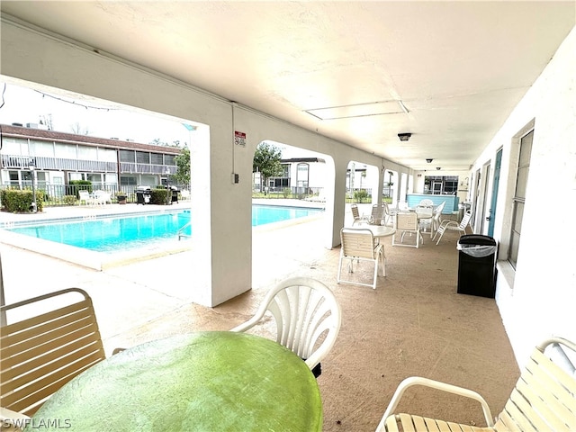 view of swimming pool with a patio area