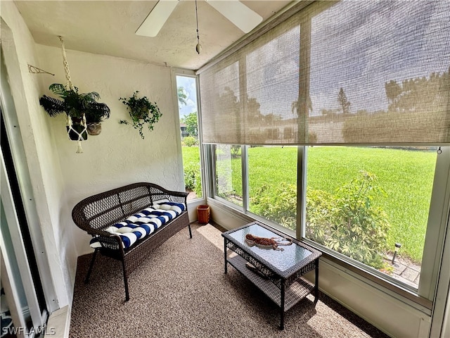 sunroom featuring ceiling fan and a wealth of natural light