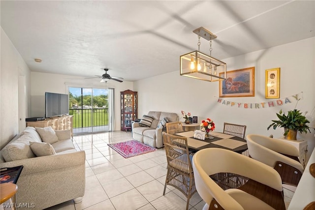 tiled living room with ceiling fan with notable chandelier