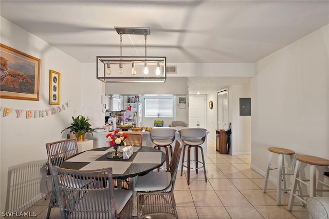 tiled dining room with electric panel