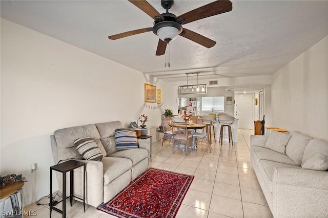 tiled living room featuring ceiling fan