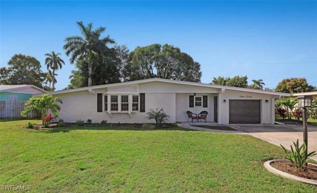 ranch-style house featuring a garage and a front lawn