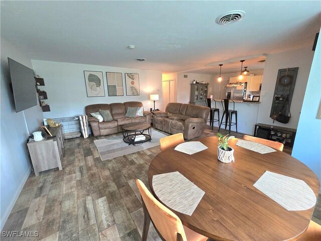 dining space with dark hardwood / wood-style floors