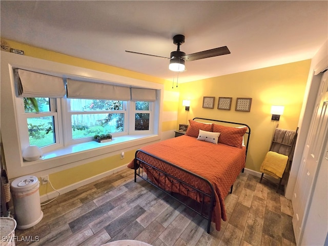 bedroom with ceiling fan and hardwood / wood-style flooring