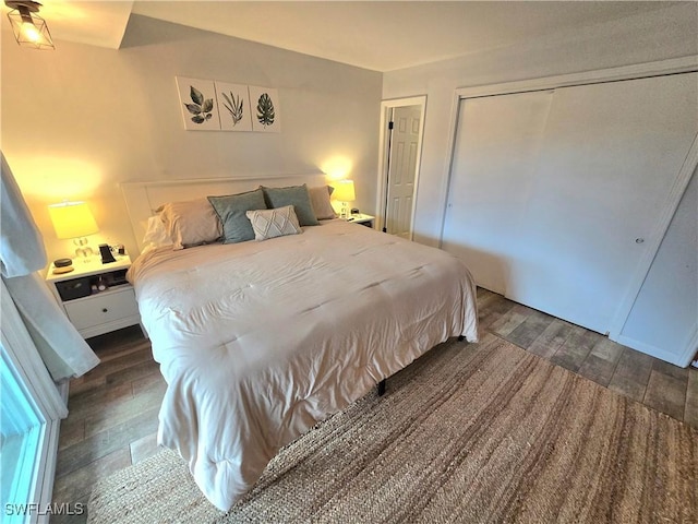 bedroom featuring dark hardwood / wood-style floors and a closet