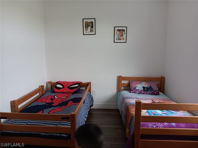 bedroom with dark wood-type flooring