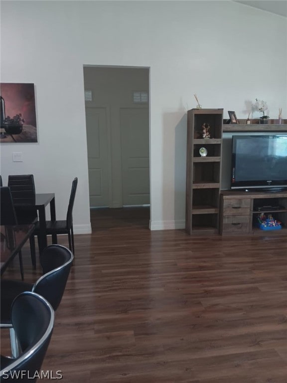 interior space featuring dark hardwood / wood-style floors and lofted ceiling