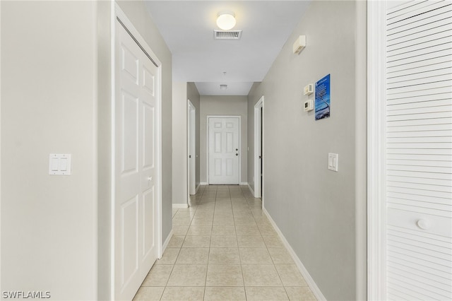 hallway with light tile patterned floors