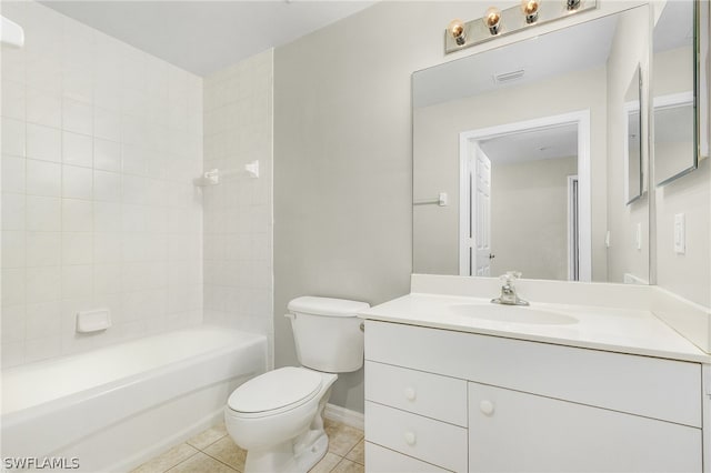 full bathroom with tile patterned flooring, tiled shower / bath combo, vanity, and toilet