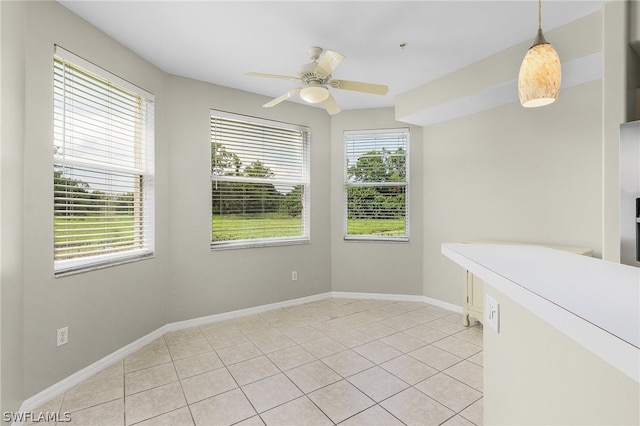 unfurnished room featuring light tile patterned flooring and ceiling fan