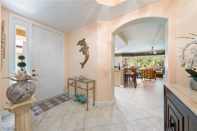 foyer entrance featuring sink, light tile patterned floors, and ceiling fan